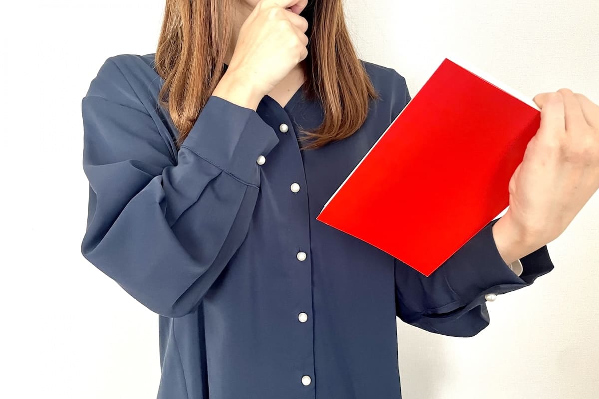調査報告書のサンプルを見る女性のイメージ