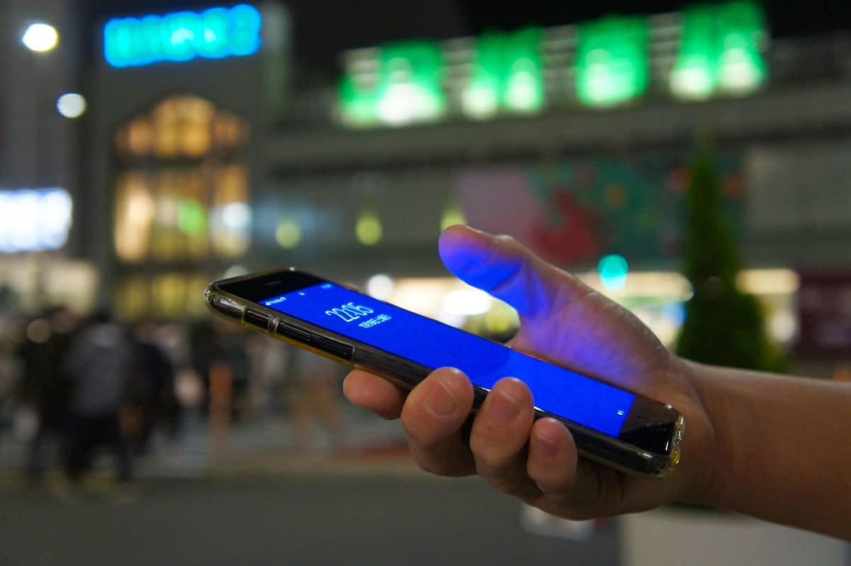 探偵が依頼者へ調査状況をスマホで伝えているイメージ